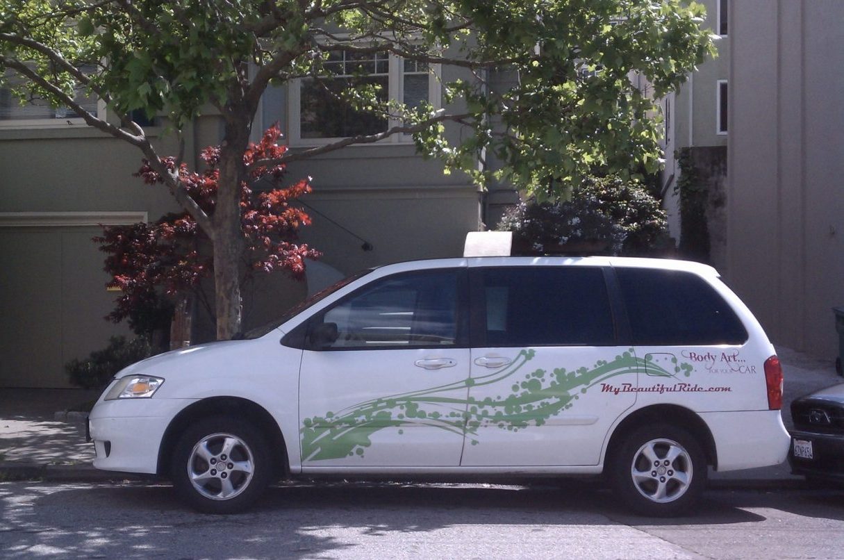 White Mazda Van with green bubble decals